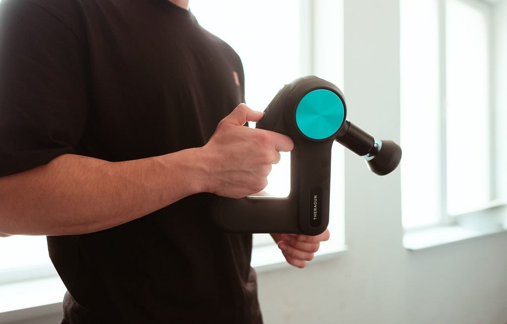 Handheld massage gun.